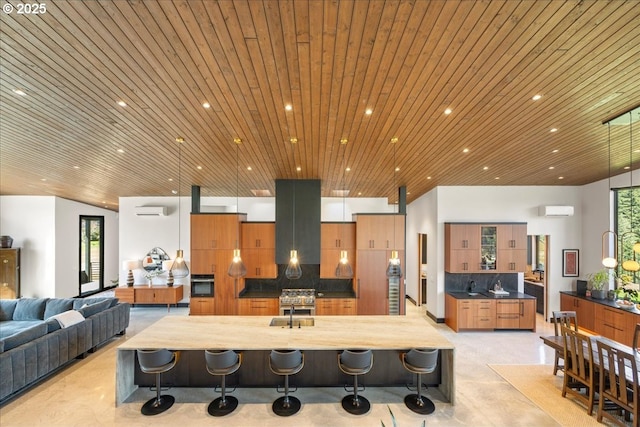 725 NW Angel Heights Rd, Stevenson, WA 98648 - kitchen with a kitchen bar, brown cabinetry, and open floor plan