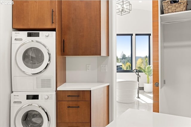 725 NW Angel Heights Rd, Stevenson, WA 98648 - washroom featuring cabinet space and stacked washing maching and dryer