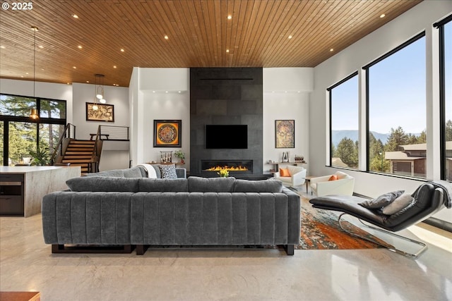 725 NW Angel Heights Rd, Stevenson, WA 98648 - living room featuring wood ceiling, a fireplace, recessed lighting, and concrete floors
