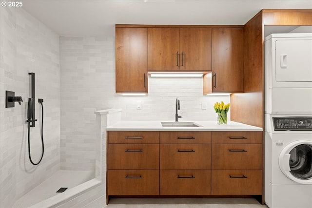 725 NW Angel Heights Rd, Stevenson, WA 98648 - washroom with stacked washer / drying machine, a sink, and laundry area