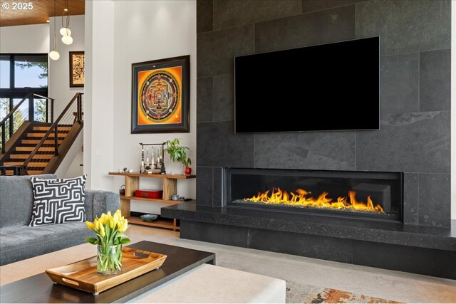 725 NW Angel Heights Rd, Stevenson, WA 98648 - living area featuring stairs and a tiled fireplace