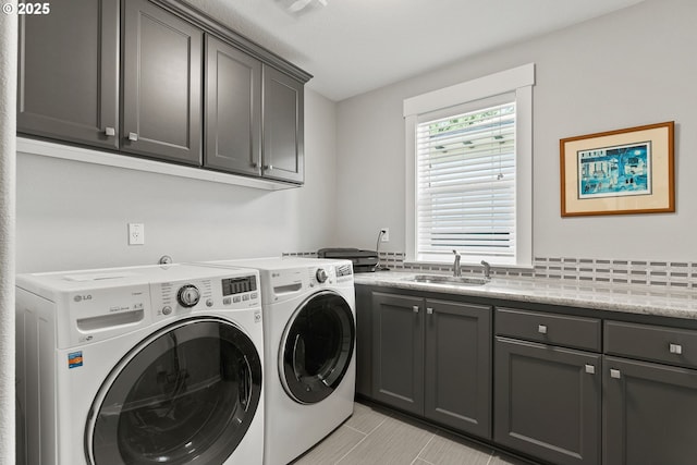 laundry room featuring cabinet space and washer and clothes dryer