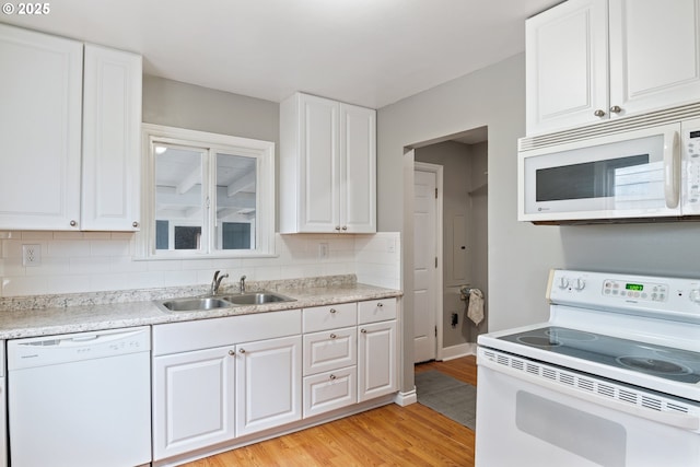 3153 Florida St, Longview, WA 98632 - kitchen featuring sink, white appliances, white cabinets, decorative backsplash, and light wood-type flooring