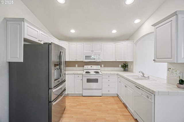 5661 J St, Washougal, WA 98671 - kitchen featuring white appliances, a sink, recessed lighting, light wood-type flooring, and white cabinets
