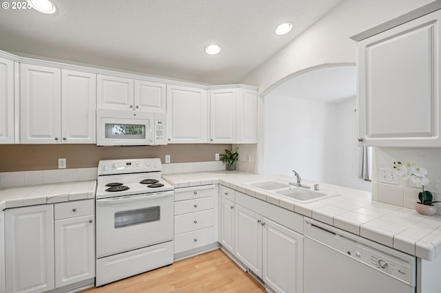 5661 J St, Washougal, WA 98671 - kitchen featuring white appliances, a sink, white cabinets, recessed lighting, and arched walkways