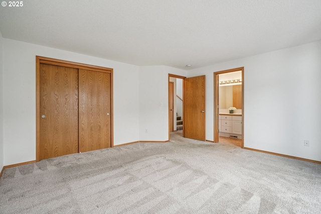 5661 J St, Washougal, WA 98671 - unfurnished bedroom with light carpet, a closet, baseboards, and ensuite bath