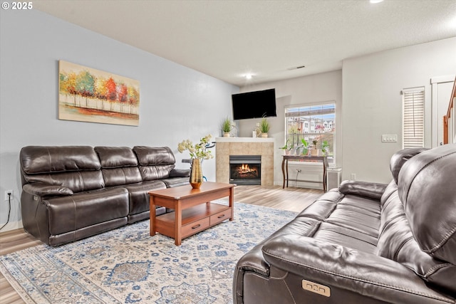 2590 NW 2nd Ter, Gresham, OR 97030 - living room with wood finished floors, a tiled fireplace, and recessed lighting
