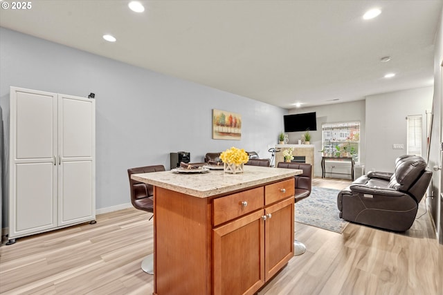 2590 NW 2nd Ter, Gresham, OR 97030 - kitchen featuring light wood-style flooring, open floor plan, recessed lighting, light countertops, and a center island