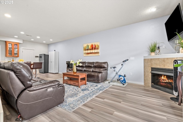 2590 NW 2nd Ter, Gresham, OR 97030 - living room featuring light wood-style floors, recessed lighting, and a tiled fireplace