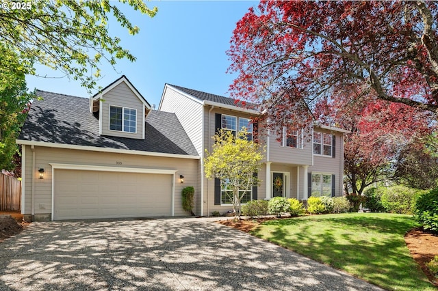 305 SW 169th Pl, Beaverton, OR 97006 - traditional home with driveway, a garage, a front yard, and roof with shingles