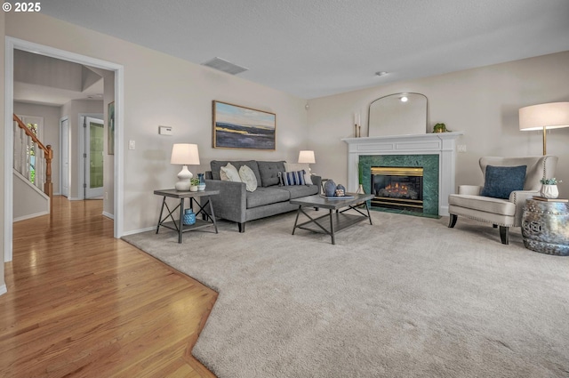 305 SW 169th Pl, Beaverton, OR 97006 - living room with wood finished floors, a premium fireplace, baseboards, and stairs