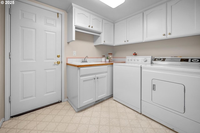305 SW 169th Pl, Beaverton, OR 97006 - laundry room with separate washer and dryer, light flooring, cabinet space, and baseboards