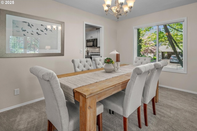 305 SW 169th Pl, Beaverton, OR 97006 - dining area with a chandelier, baseboards, and carpet flooring