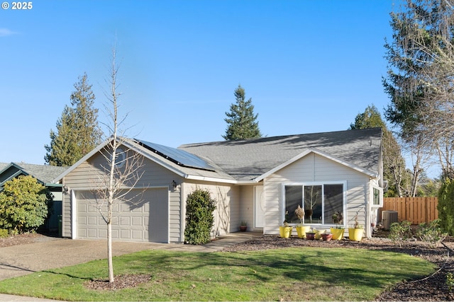 ranch-style home with solar panels, central air condition unit, a front yard, and a garage