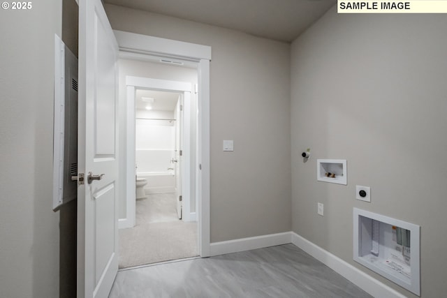 washroom featuring hookup for an electric dryer, washer hookup, and baseboards