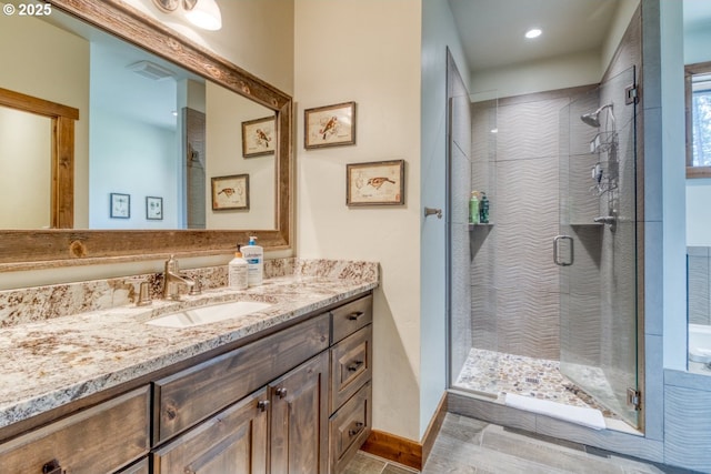 bathroom with an enclosed shower and vanity