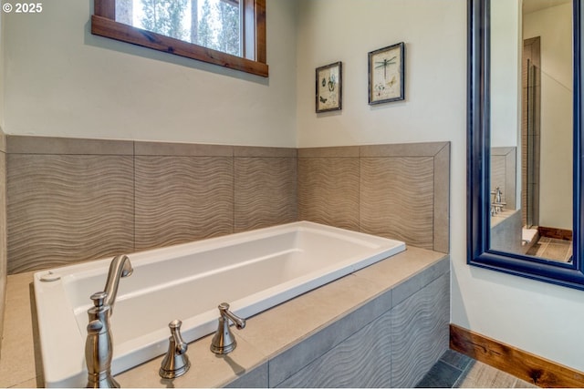 bathroom featuring tiled tub