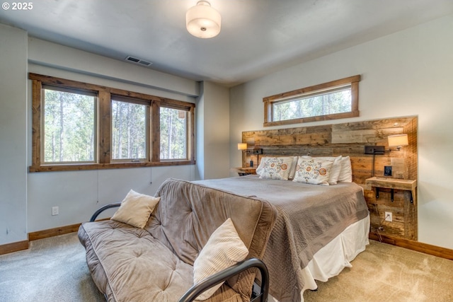 bedroom featuring light carpet and multiple windows