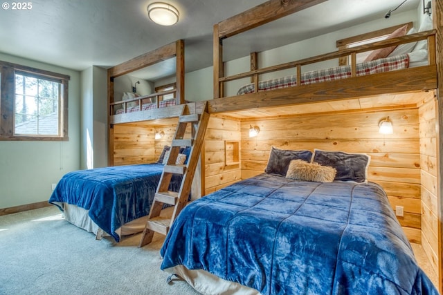 carpeted bedroom featuring wood walls