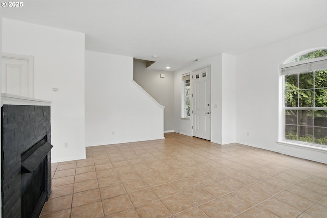 11660 SW Longspur Ter, Beaverton, OR 97007 - unfurnished living room featuring light tile patterned floors, a fireplace, stairway, and recessed lighting