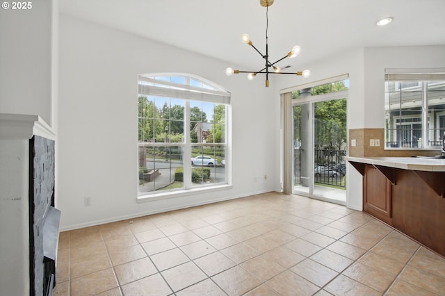11660 SW Longspur Ter, Beaverton, OR 97007 - unfurnished dining area with a chandelier, healthy amount of natural light, light tile patterned flooring, a sink, and recessed lighting