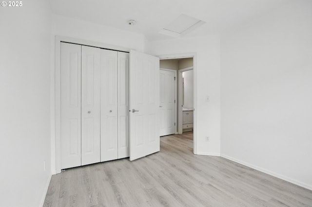 11660 SW Longspur Ter, Beaverton, OR 97007 - unfurnished bedroom with light wood-type flooring, baseboards, attic access, and a closet