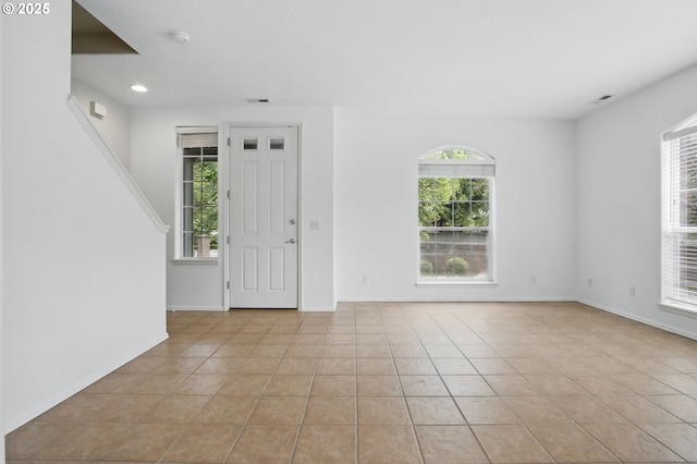 11660 SW Longspur Ter, Beaverton, OR 97007 - foyer featuring healthy amount of natural light, light tile patterned flooring, baseboards, and recessed lighting
