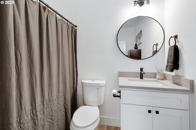 bathroom with vanity, toilet, and curtained shower