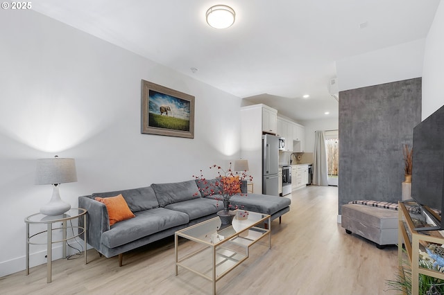 living room with light wood-type flooring and sink