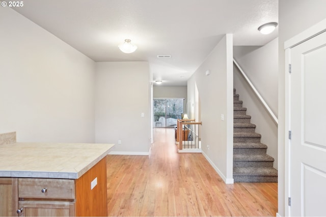 interior space featuring a textured ceiling and light hardwood / wood-style flooring