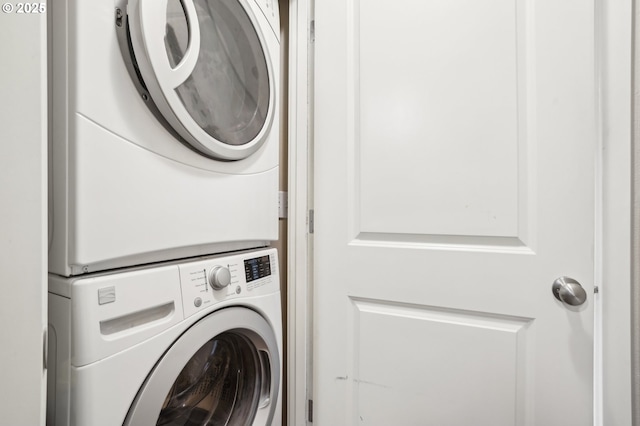 laundry area with stacked washer and clothes dryer