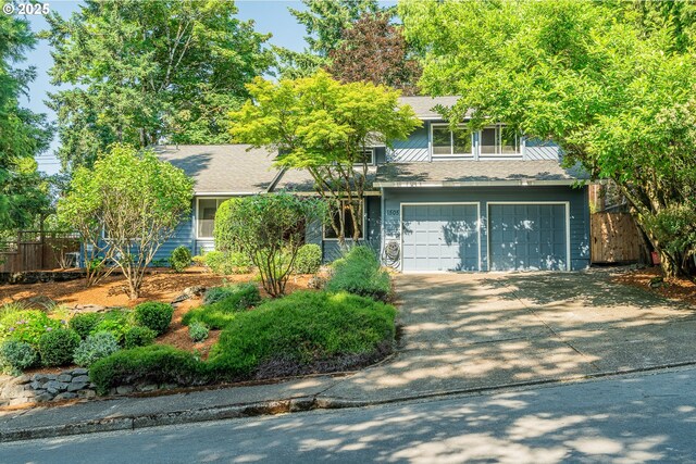 1505 NW 118th Ct, Portland, OR 97229 - obstructed view of property featuring driveway, an attached garage, and roof with shingles