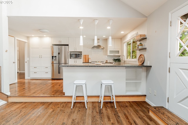 1505 NW 118th Ct, Portland, OR 97229 - kitchen featuring appliances with stainless steel finishes, open shelves, wall chimney range hood, a peninsula, and white cabinetry