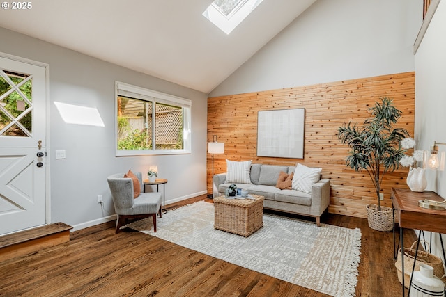 1505 NW 118th Ct, Portland, OR 97229 - living room featuring a skylight, healthy amount of natural light, high vaulted ceiling, wood finished floors, and wood walls