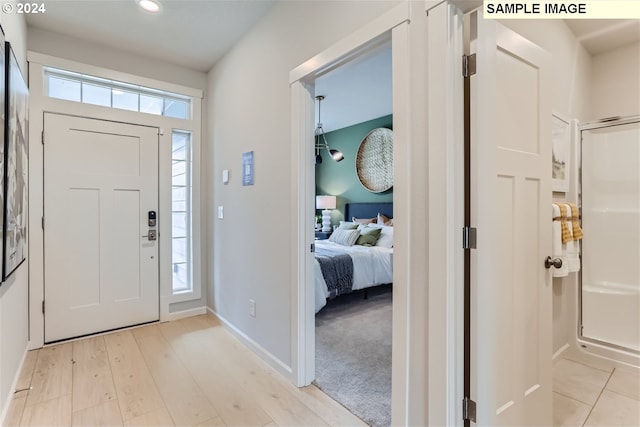 entryway featuring a wealth of natural light and light hardwood / wood-style flooring