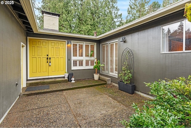 property entrance featuring a patio area