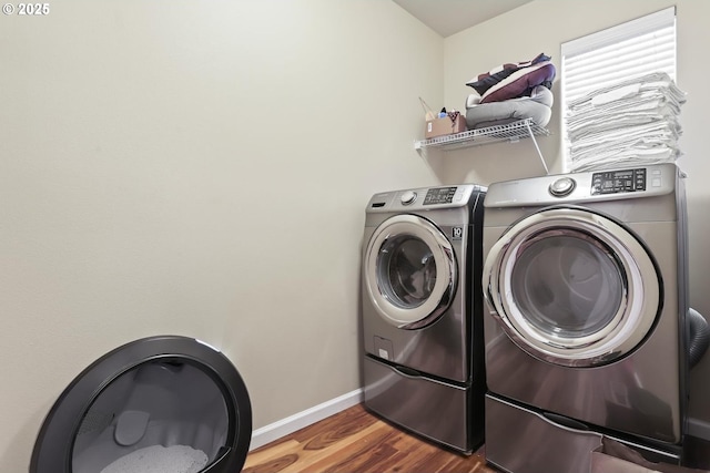 laundry area with washer and dryer and hardwood / wood-style floors