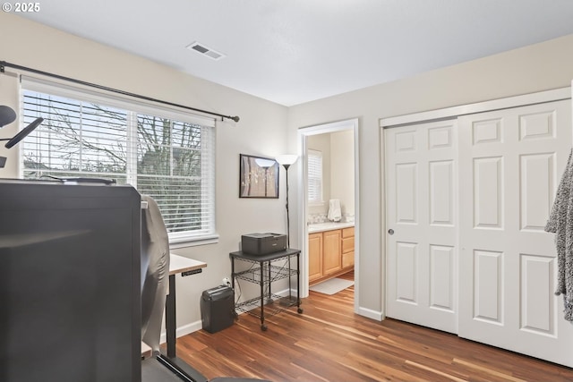 office space with dark wood-type flooring