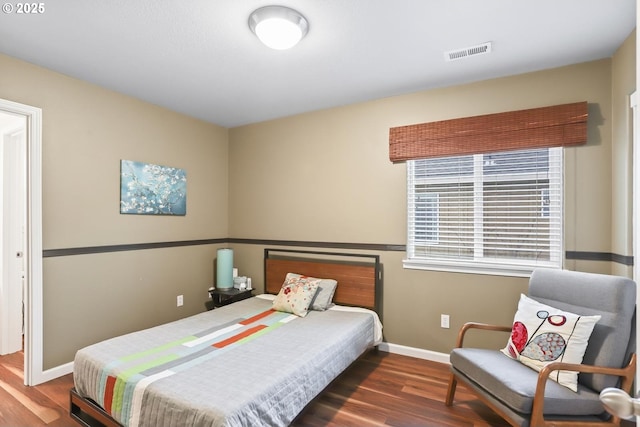 bedroom with dark hardwood / wood-style flooring