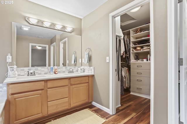 bathroom with vanity, hardwood / wood-style flooring, and backsplash