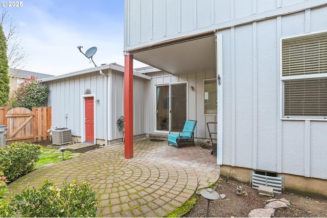 rear view of property with cooling unit and a patio area