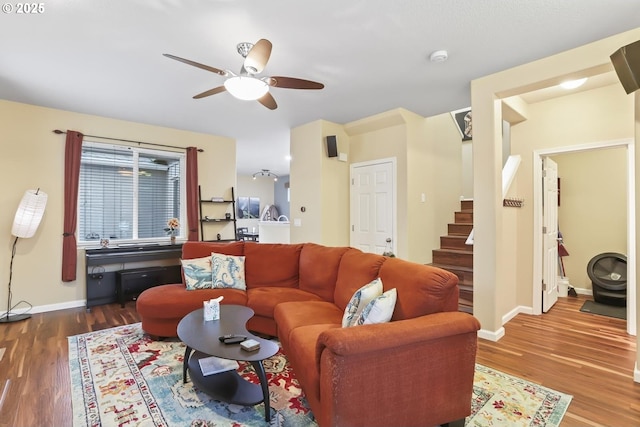 living room featuring ceiling fan and hardwood / wood-style floors