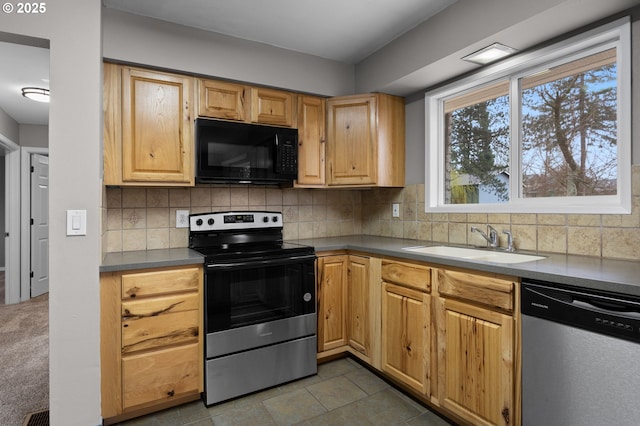 kitchen featuring a sink, backsplash, and stainless steel appliances