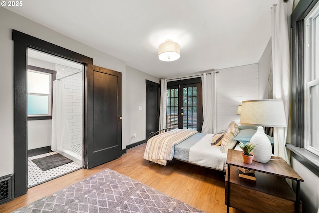 bedroom with light hardwood / wood-style flooring and french doors