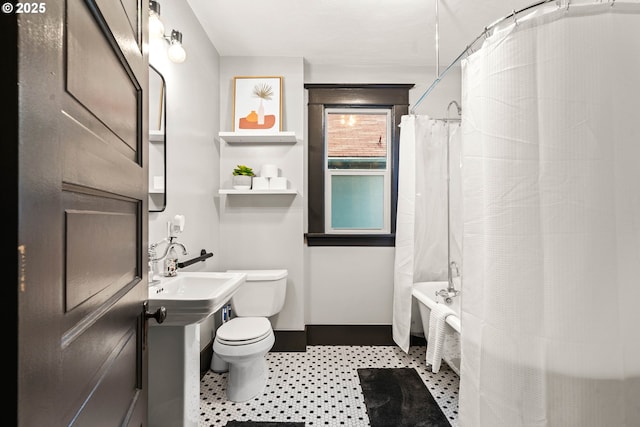 bathroom with shower / bath combo and toilet