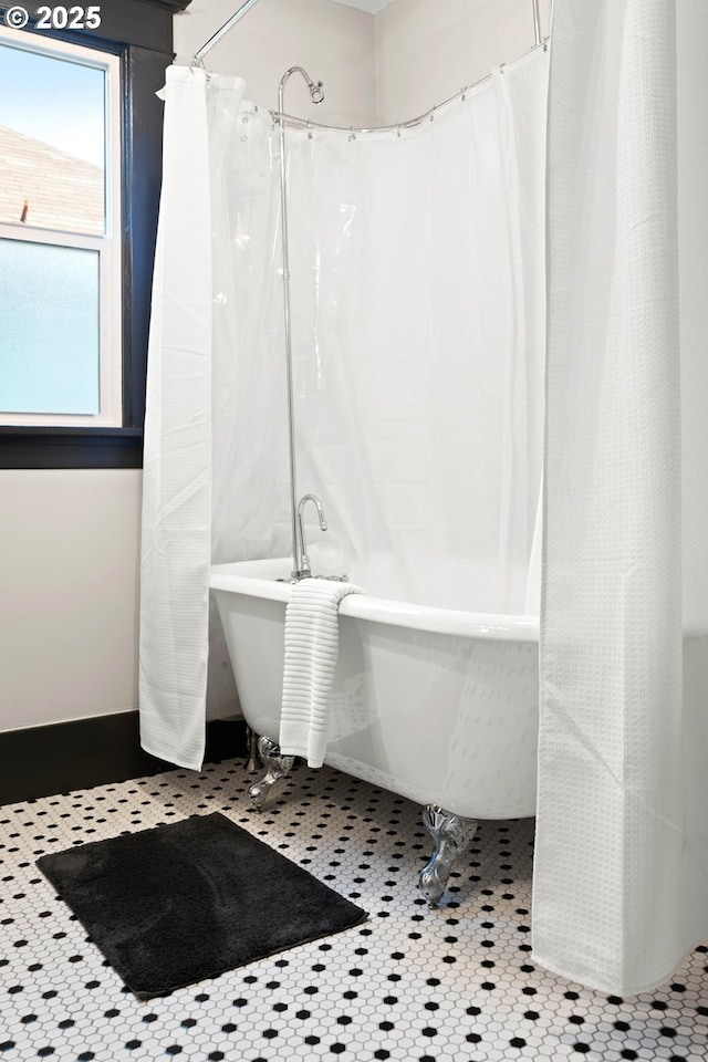 bathroom with tile patterned flooring and shower / bath combination with curtain