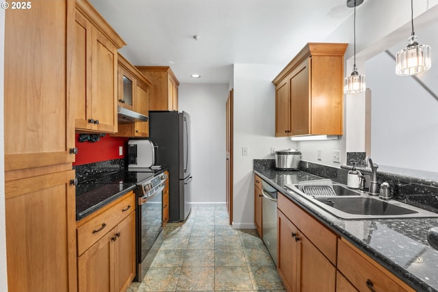 kitchen featuring stainless steel appliances, a sink, under cabinet range hood, baseboards, and stone finish flooring