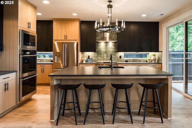 1006 S 48th Pl, Ridgefield, WA 98642 - kitchen with appliances with stainless steel finishes, dark countertops, tasteful backsplash, light wood-type flooring, and recessed lighting