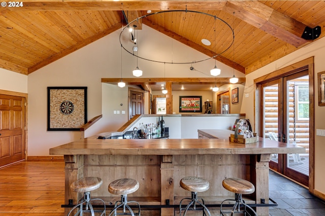 bar featuring decorative light fixtures, high vaulted ceiling, and wood ceiling