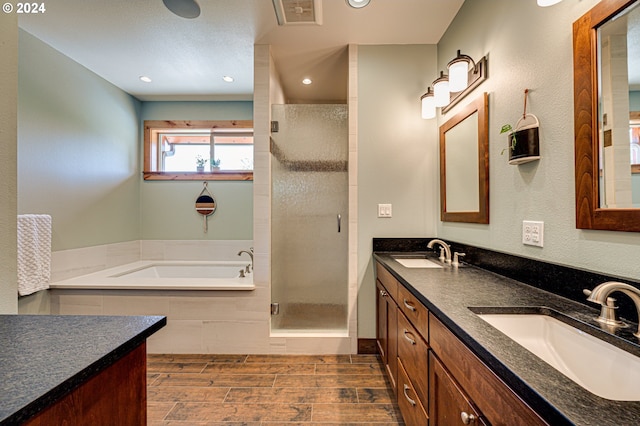 bathroom with shower with separate bathtub and vanity